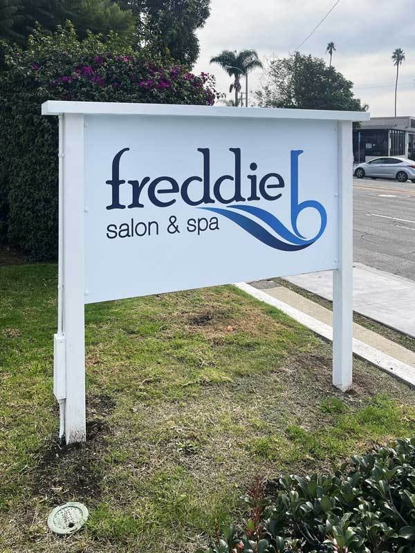Freddie B Salon & Spa has this post and panel sign next to the road. It complements the halo-lit channel letter sign on the building (You'll find it in our sign galleries).