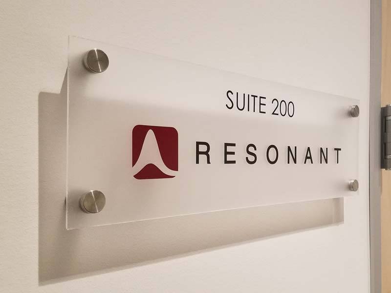 Frosted acrylic office suite signs like this one for Resonant are popular and have a timeless look.