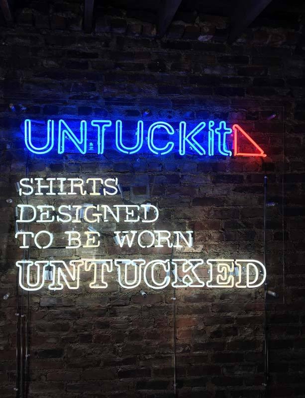UNTUCKit neon sign in their corporate office in New York City.