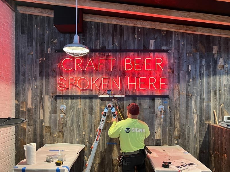 Finney's Craft Beer Spoken Here neon sign in all their locations.