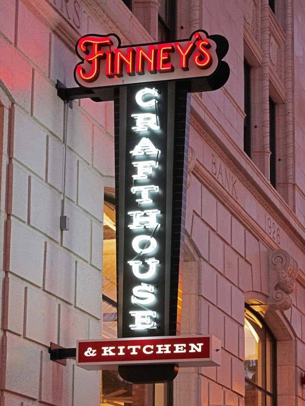 Finney's uses open-faced channel letters with neon lighting, front-lit and halo-lit channel letters with a lightbox for "& Kitchen."