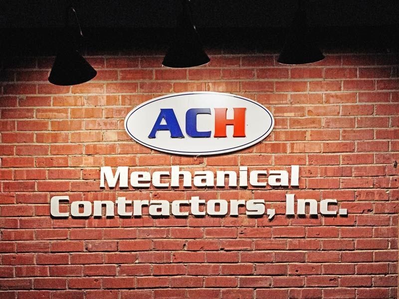 ACH Mechanical Contractors, Inc. is a dimensional letter sign that uses barn lighting for illumination.