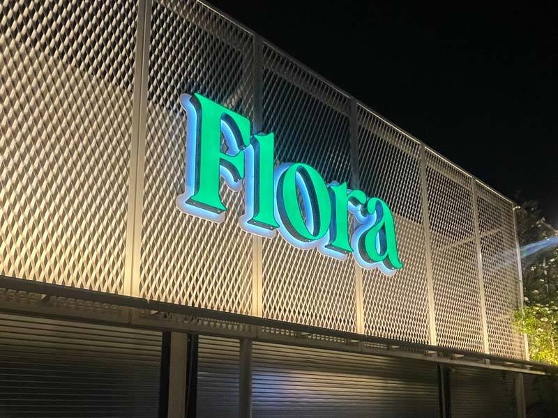 Flora in Los Angeles uses a flush mount for their custom illuminated channel letter sign.