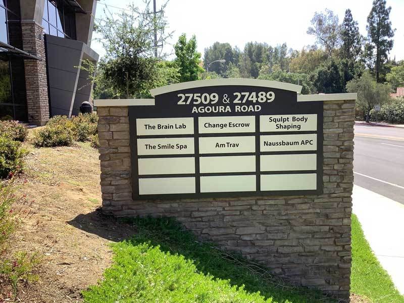 This architectural signage for APB Properties in Agoura Hills, CA matches the buildings stone structure.